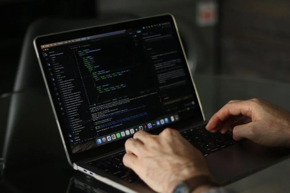 Mobile phone displaying Stripe app on a laptop with an eCommerce site open, symbolizing online shopping.